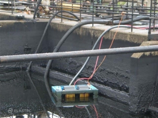 Drum skimmer in industrial pit