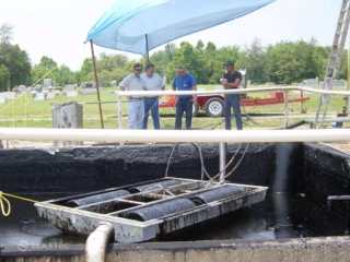 Oil skimmer in pit at graveyard
