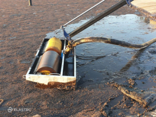 Skimming palm oil from water