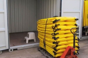 Containment boom on a pallet with a container
