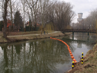 Debris control barrier in canal