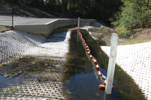Double wall permanent trash and debris boom installation