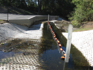 Double wall permanent trash and debris boom installation
