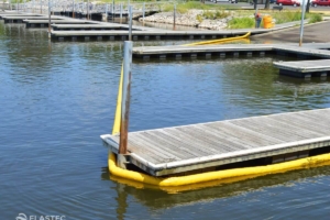 Elastec compactible oil boom around boat dock