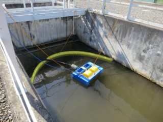 Floating boom with oil skimmer in gas plant