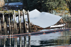 Floating inflatable containment boom