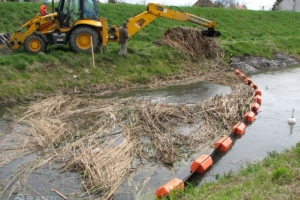 PermaFence containment boom in creek stopping floating debris