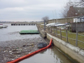 Debris boom deflecting trash