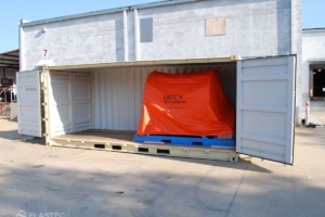 Shoremax on containment boom reel in container