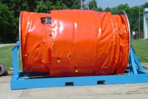 Inflatable containment boom on reel