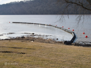 Floating log booms on the Ohio River