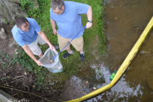 Picking up floating trash and debris in a creek