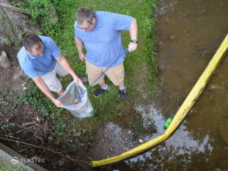 Picking up floating trash and debris in a creek