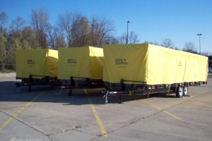 Trailers with covers for oil containment boom