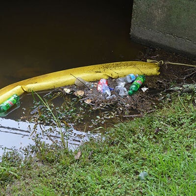 Bottle Boom with trash and debris
