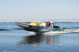 Aluminum workboat moving fast in water