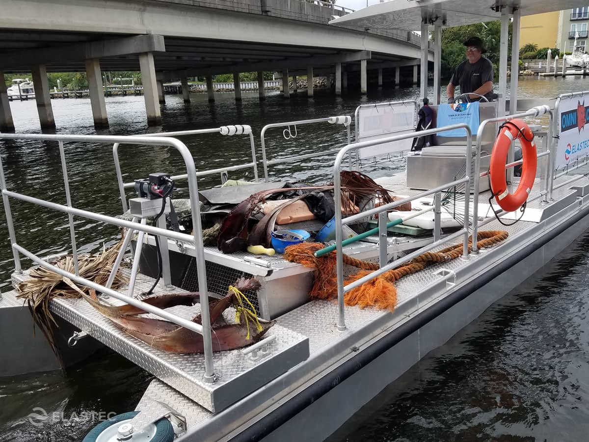 Omni Catamaran with floating trash on deck