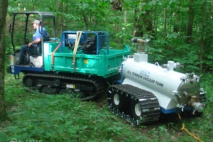 Multi-purpose crawler towing vacuum tank